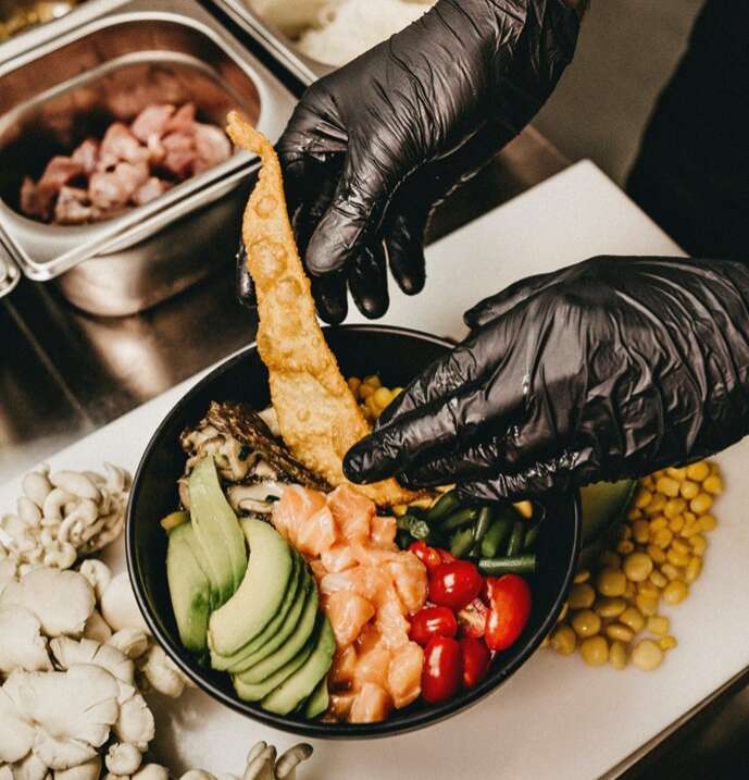 Man making healthy food with gloves on